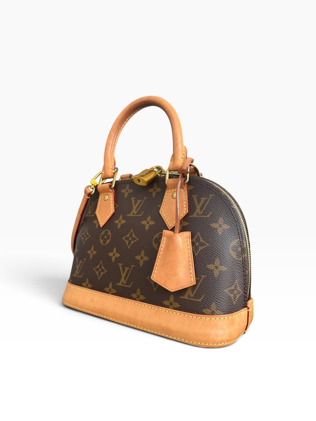 Louis Vuitton Alma BB en toile Monogram avec bandoulière amovible. Toile Monogram enduite.